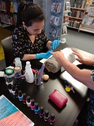 Huong Nguyen offering pampering for working women’s hands. 
